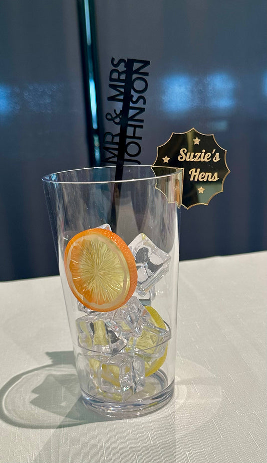 Clear glass with lemon and ice cubes, branded 'Mr & Mrs Johnson' in the background
