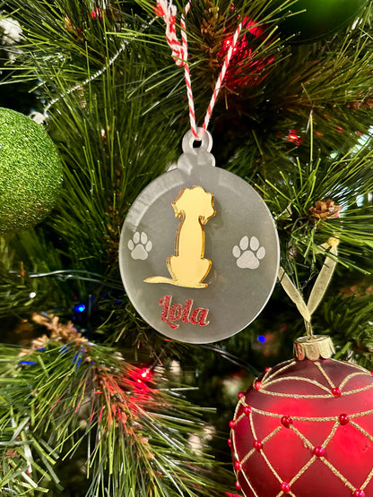 Decorative Christmas ornament with a dog design and 'Lola' engraved, hanging on a tree.
